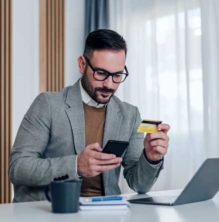 Happy businesswoman using smartphone for payments